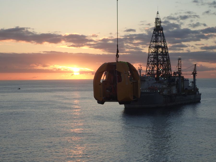 FROG-XT4 by Reflex Marine being transferred via crane by Sten Drilling with the sunset in the background.