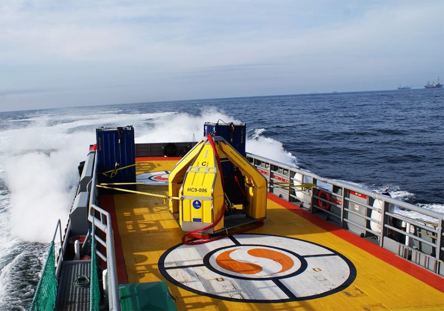 FROG-9 crane transfer device from Reflex Marine on the deck of a ship.