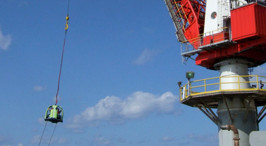 Reflex Marine TORO-4 transferring personnel via crane.