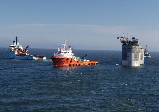 Some ships sail away from an offshore structure after completing a safe crane transfer using a Reflex marine device.