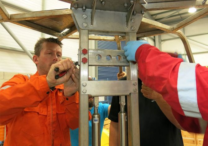 Reflex Marine staff maintain a crane transfer device.